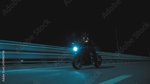 A man rides a sports motorcycle on a night track