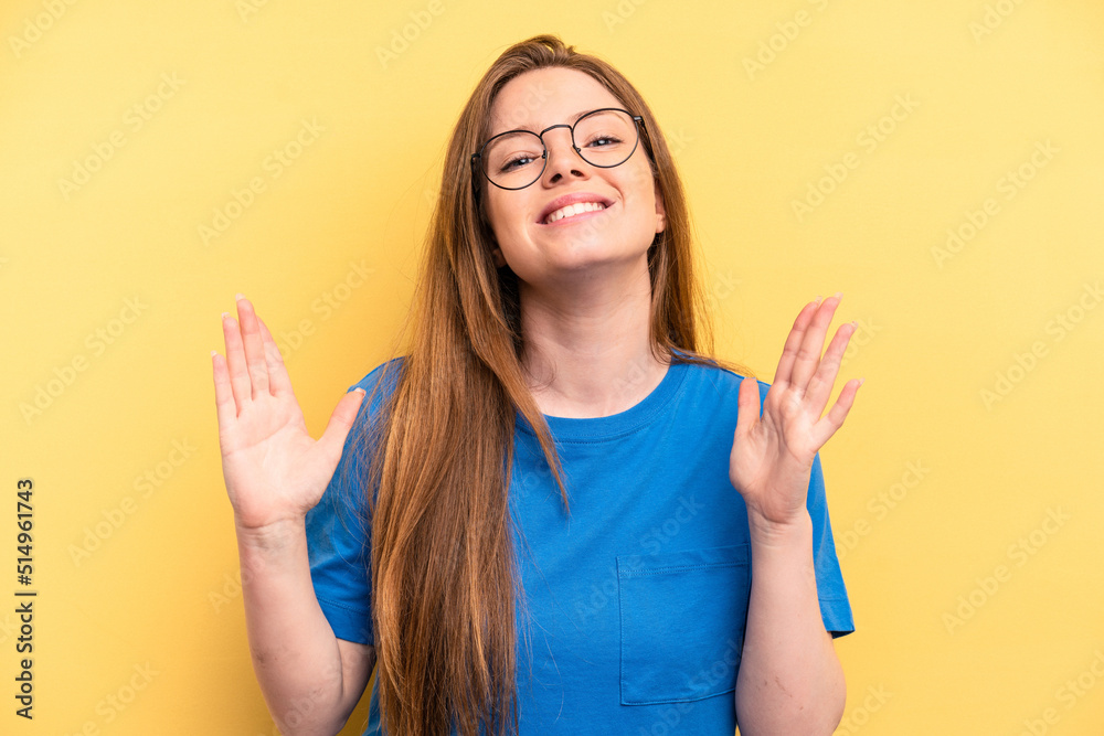 Fototapeta premium Young caucasian woman isolated on yellow background laughs out loudly keeping hand on chest.
