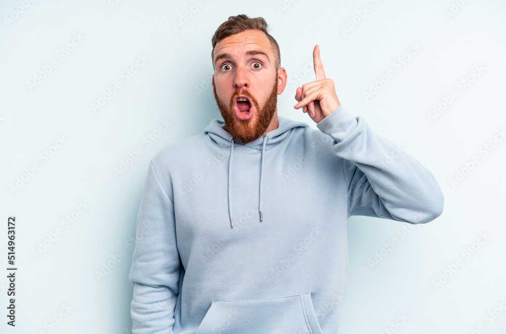 Fototapeta premium Young caucasian man isolated on blue background having some great idea, concept of creativity.