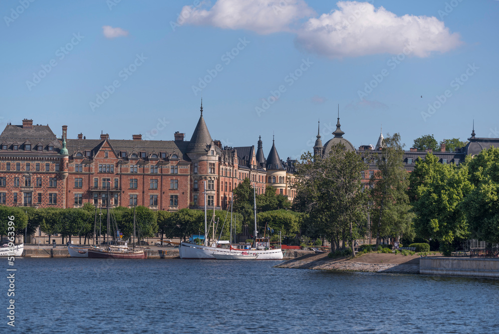 Bay view of boats at the district Östermalm with old apartment houses, a summer day in Stockholm, Sweden 2022-07-03