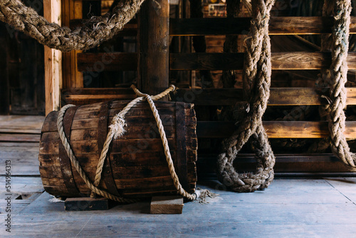 Wooden winch of a sailing ship and ropes on the deck of medieval pirate warship