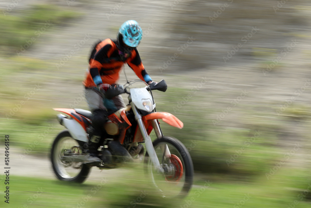 Blurry image of motorcycle riders during motocross race