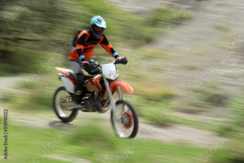 Blurry image of motorcycle riders during motocross race