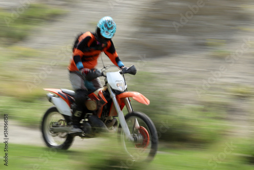 Blurry image of motorcycle riders during motocross race