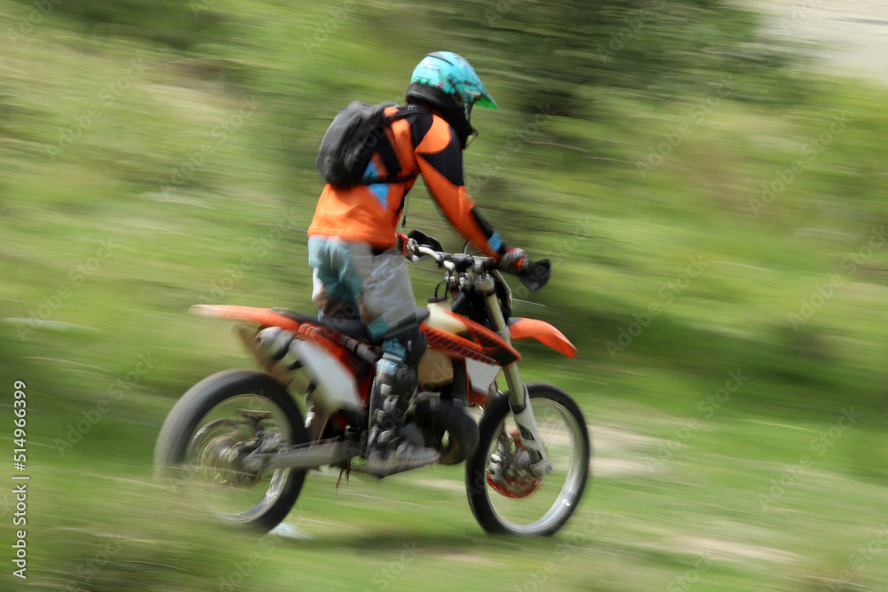 Blurry image of motorcycle riders during motocross race Blurry image of motorcycle riders during motocross race