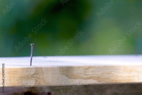 Nail in wooded deck rail