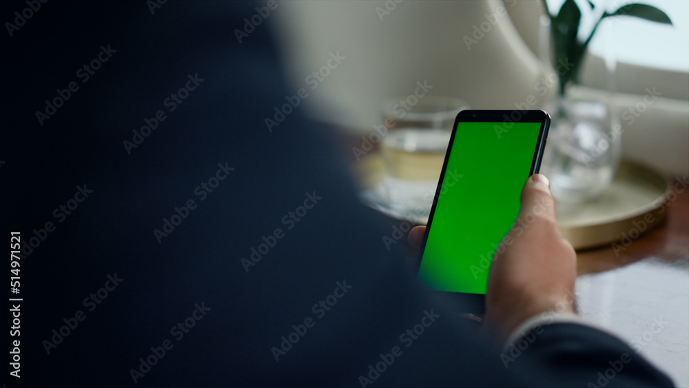 Closeup man use chroma key smartphone. Businessman hand touch green screen phone Closeup man use chroma key smartphone. Businessman hand touch green screen phone