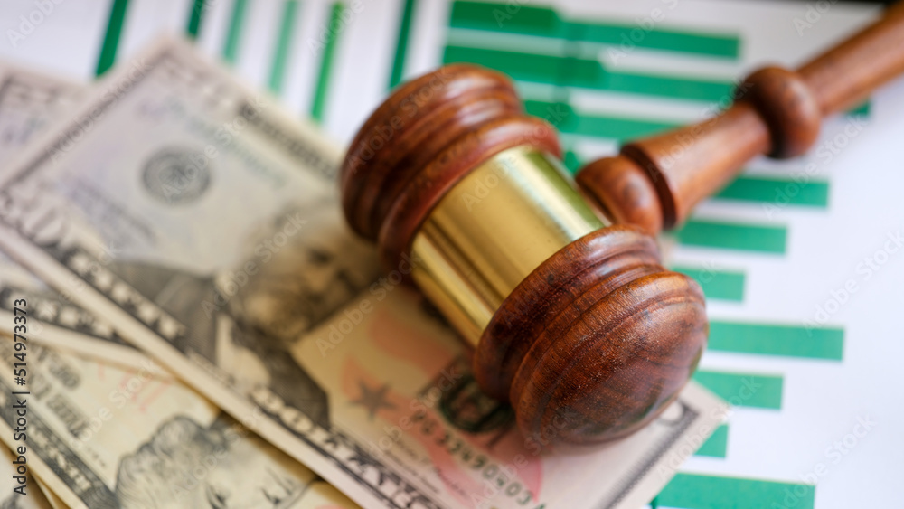 Judge gavel, banknotes and business financial documents Judge gavel, banknotes and business financial documents