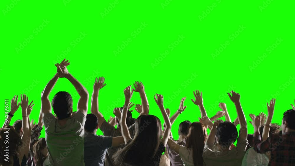 Group of young people or fans dancing , jumping and having fun on green screen. You can install different backgrounds of public place , concert stadium , disco clubs . Shot on RED camera . slow motion