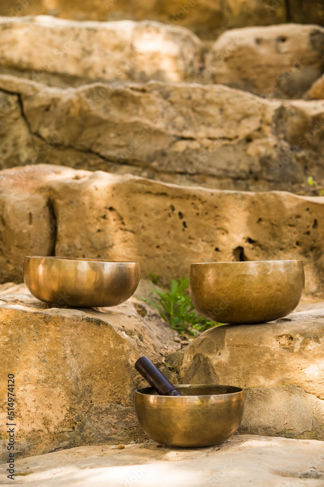 Fototapeta premium Still life with Tibetan bowls on rocks.