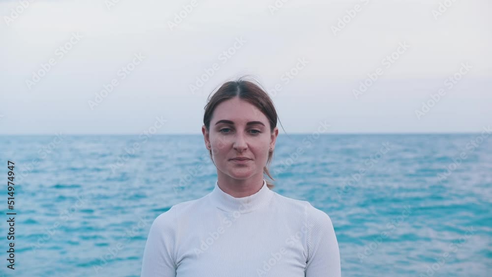 An adult woman breathing on the shore of the blue sea An adult woman breathing on the shore of the blue sea