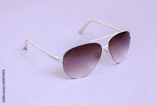 Aviator glasses with gradient lenses on a purple background