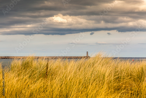 The old, red, wooden Herd Groyne Lighthouse in South Shields, stands out against the cloudy sky  © Paul Jackson