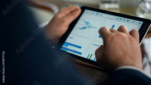 Entrepreneur hands using tablet check finance graphics on business trip closeup