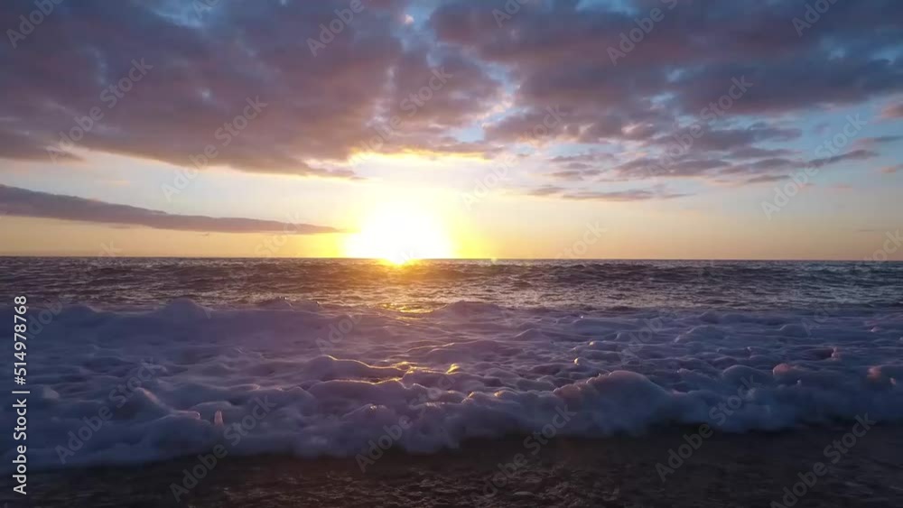 Sun setting over the Mediterranean sea, waves coming towards camera Sun setting over the Mediterranean sea, waves coming towards camera