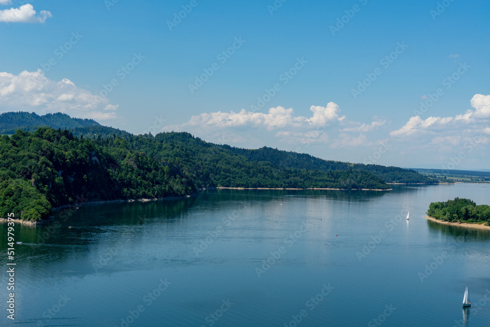 Lake Czorsztynskie and sailing boats on it in the summer noon