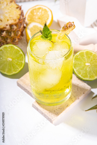 Cold summer tropical drink with crushed ice, lime and mint. Sweet pineapple lemonade copy space