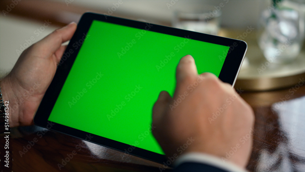 Closeup hands using green screen pad. Wealthy man touch digital tablet computer Closeup hands using green screen pad. Wealthy man touch digital tablet computer