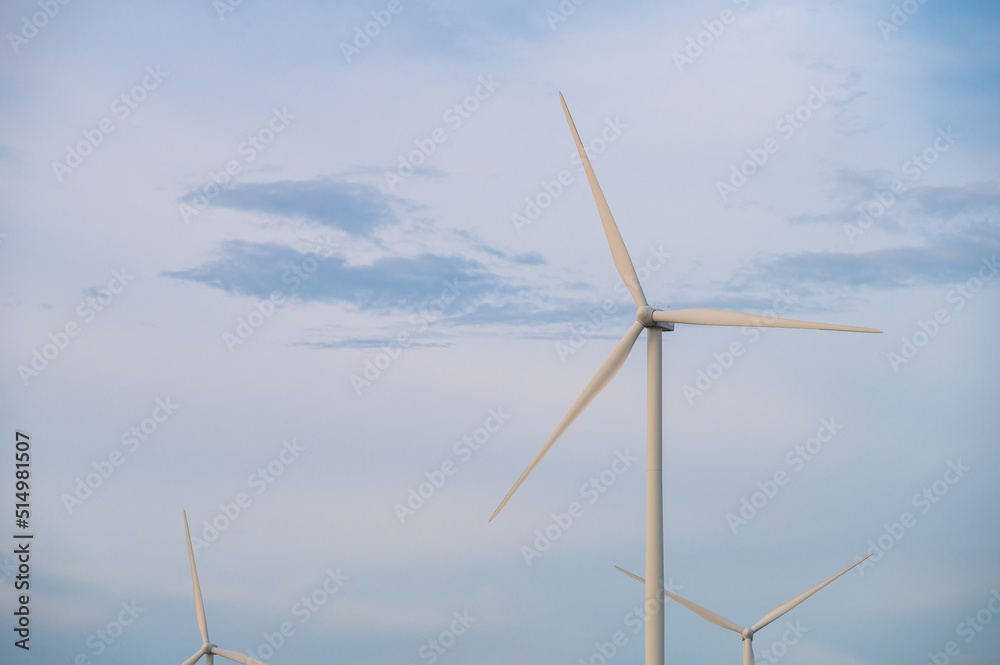 Fototapeta premium Wind turbine generator with blue sky - energy conservation concept. thailand