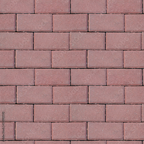 Background of seamless texture of masonry road made of dark pink brick. Top view