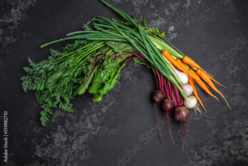 Bunch of fresh organic beetroots and carrots with green leaves. onion garlic heads  The concept of agriculture and gardening  growing and caring for vegetables. top view