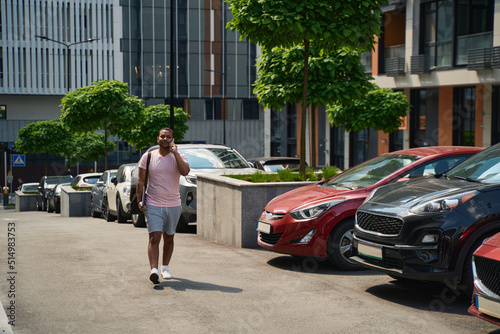 Wallpaper Mural Serious man calling on smartphone in business district Torontodigital.ca