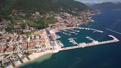 Aerial View of Portonovi Resort, Kumbor, Montenegro. Marina and Luxury Bayfront Buildings on Sunny Day, Establishing Drone Shot photo