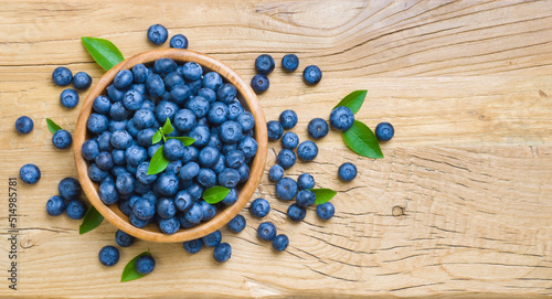 Fototapeta Naklejka Na Ścianę i Meble -  Top view of blueberries in wooden bowl on rustic table