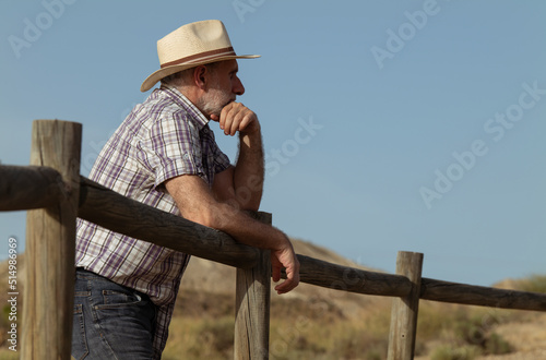 Portrait of adult man in sun hat and shirt in desert