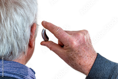 Hearing aid in a senior man, hearing disorder photo