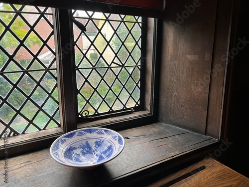Fényképezés Close up of medieval Elizabethan leaded glass window diamond shape thick hand bl