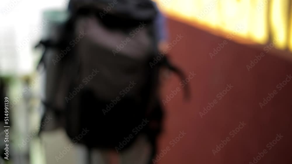 close up of a man picking up a backpack and hanging it on the shoulder to leave close up of a man picking up a backpack and hanging it on the shoulder to leave