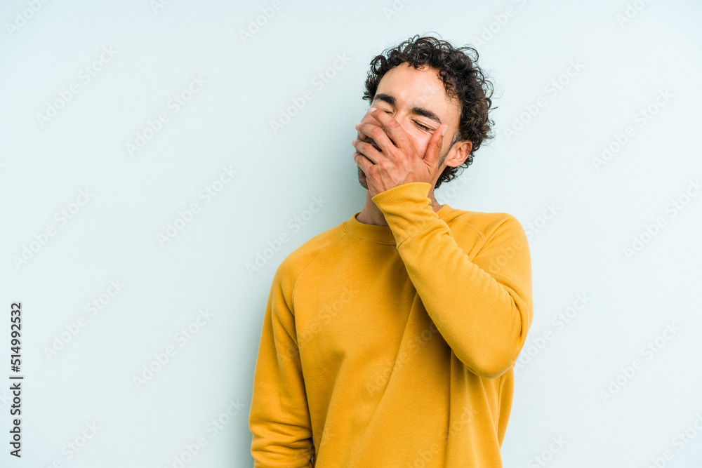 Young caucasian man isolated on blue background laughing happy, carefree, natural emotion. Young caucasian man isolated on blue background laughing happy, carefree, natural emotion.