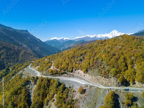 Fototapeta Naklejka Na Ścianę i Meble -  Beautiful, atmospheric autumn view from a drone on a serpentine in the mountains on a sunny day