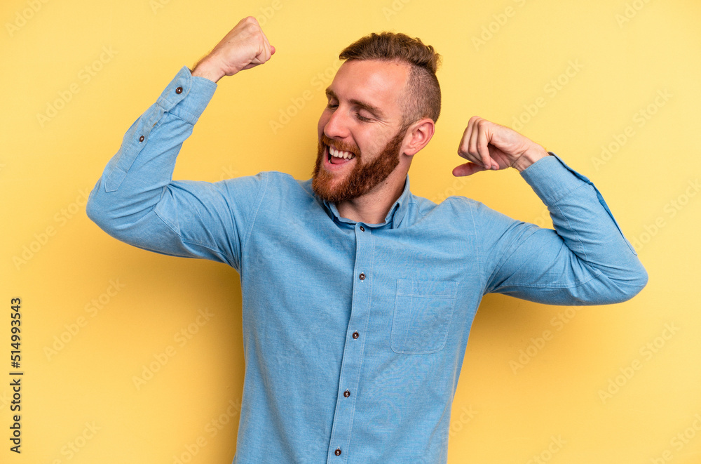 Young caucasian man isolated on yellow background celebrating a special day, jumps and raise arms with energy. Young caucasian man isolated on yellow background celebrating a special day, jumps and raise arms with energy.