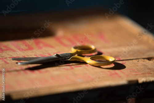yellow scissors on wood