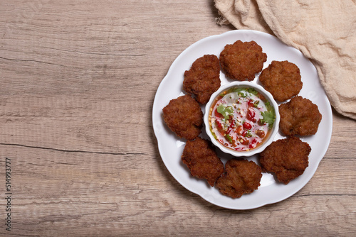 Fried Pork Cake with Ketchup and Chili Sauce on a white table top view. Asia Travel Cuisine concept.