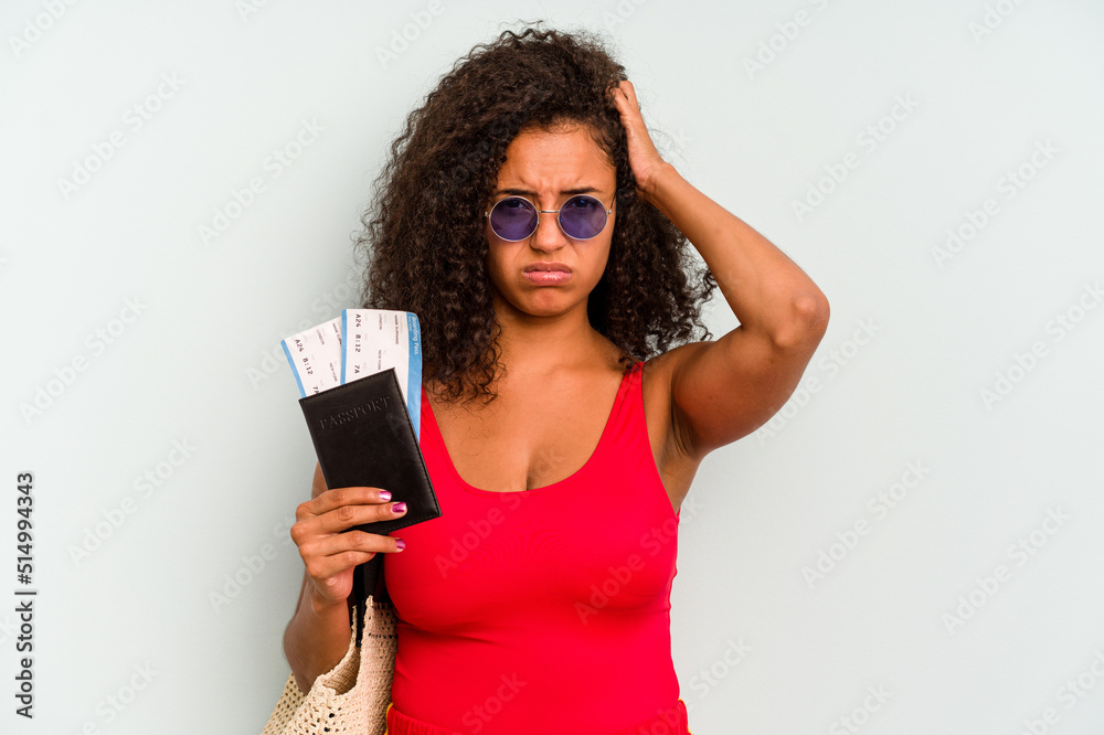 Young brazilian woman wearing a swimsuit isolated on blue background being shocked, she has remembered important meeting. Young brazilian woman wearing a swimsuit isolated on blue background being shocked, she has remembered important meeting.