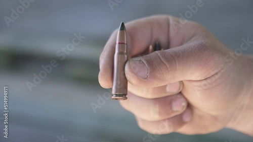 Armor-piercing cartridge 7.62x39 mm close-up holden in fingers