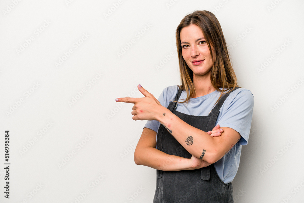 Young caucasian pregnant woman isolated on white background smiling cheerfully pointing with forefinger away.
