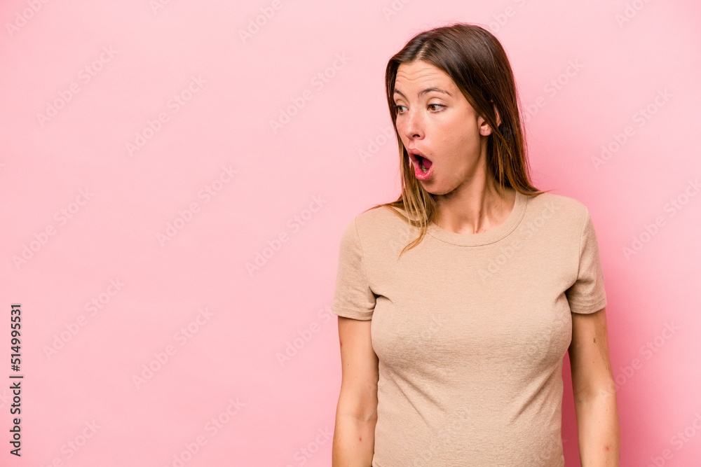 Young caucasian pregnant woman isolated on white background being shocked because of something she has seen. Young caucasian pregnant woman isolated on white background being shocked because of something she has seen.