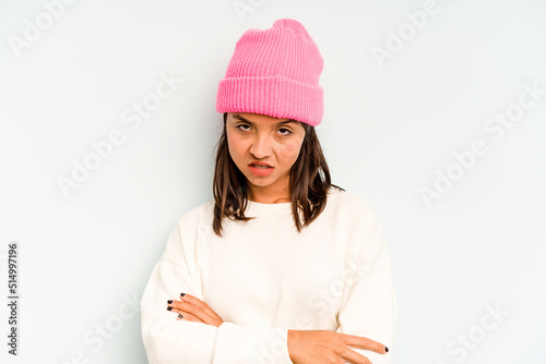 Young hispanic woman isolated on blue background relaxed and happy laughing, neck stretched showing teeth.