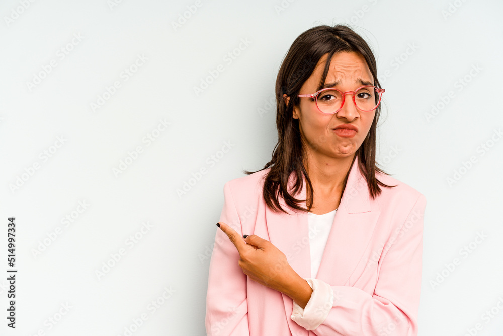 Young hispanic woman isolated on blue background keeping two arms crossed, denial concept. Young hispanic woman isolated on blue background keeping two arms crossed, denial concept.