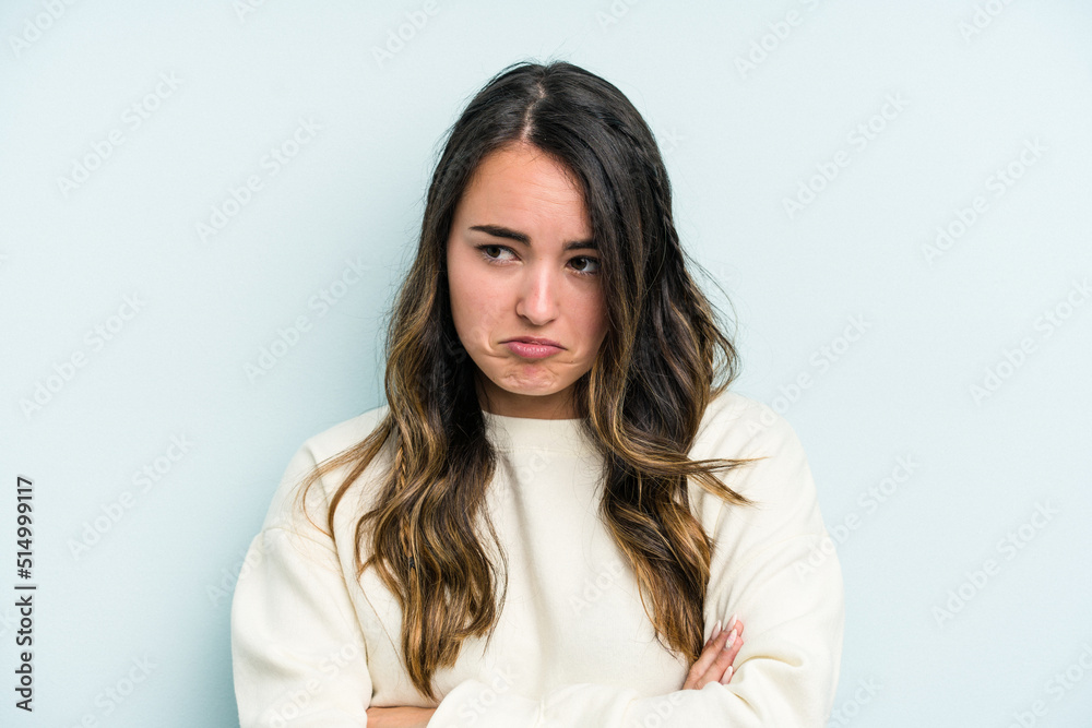 Young caucasian woman isolated on blue background tired of a repetitive task. Young caucasian woman isolated on blue background tired of a repetitive task.