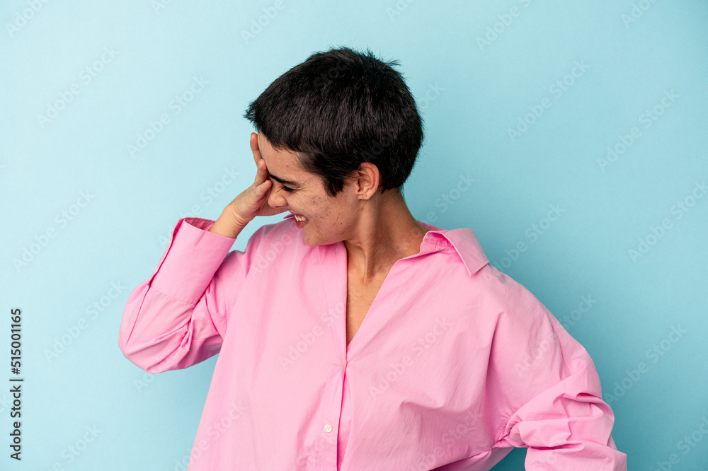 Young caucasian woman isolated on blue background joyful laughing a lot. Happiness concept. Young caucasian woman isolated on blue background joyful laughing a lot. Happiness concept.