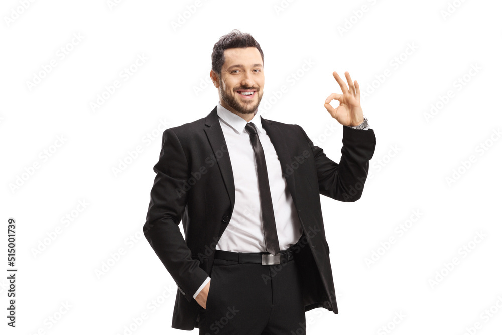 Young man wearing black suit and gesturing ok sign Young man wearing black suit and gesturing ok sign