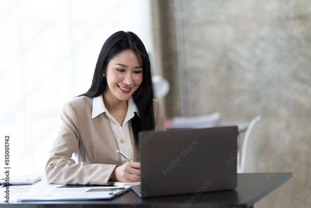 Asian woman working with laptop in her office. business financial concept. Asian woman working with laptop in her office. business financial concept.