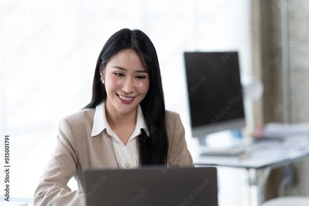 Asian woman working with laptop in her office. business financial concept. Asian woman working with laptop in her office. business financial concept.