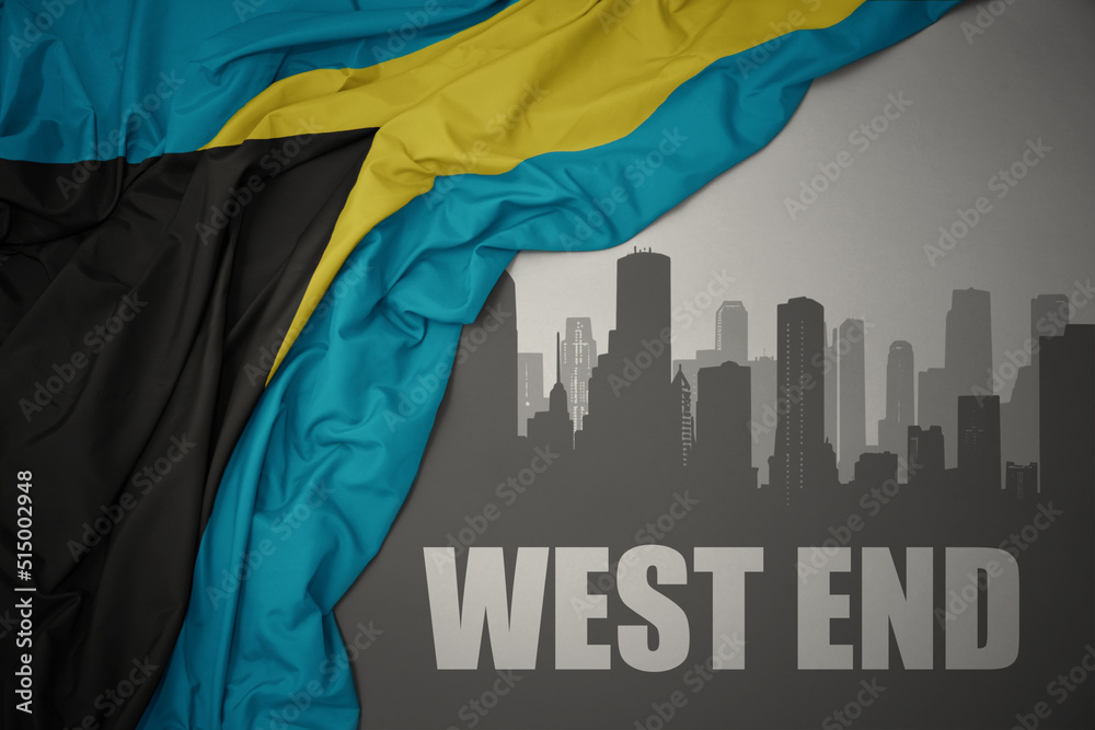 abstract silhouette of the city with text West End near waving national flag of bahamas on a gray background. 3D illustration