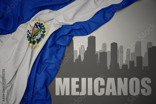 abstract silhouette of the city with text Mejicanos near waving national flag of el salvador on a gray background. 3D illustration photo